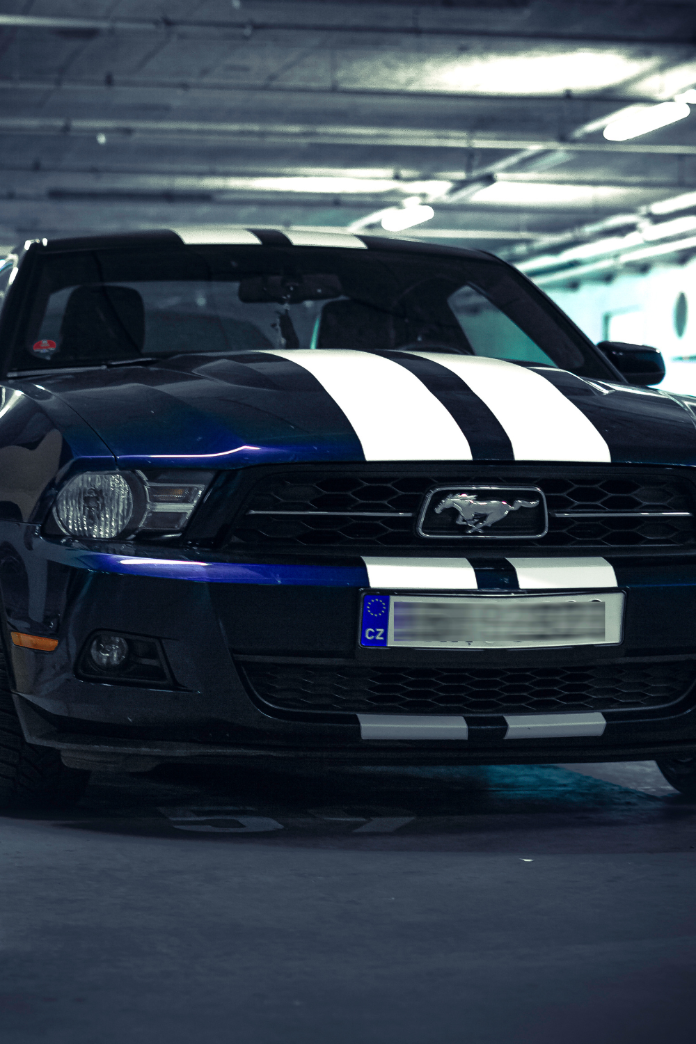 Blue sports car with white vehicle graphics racing stripe kit