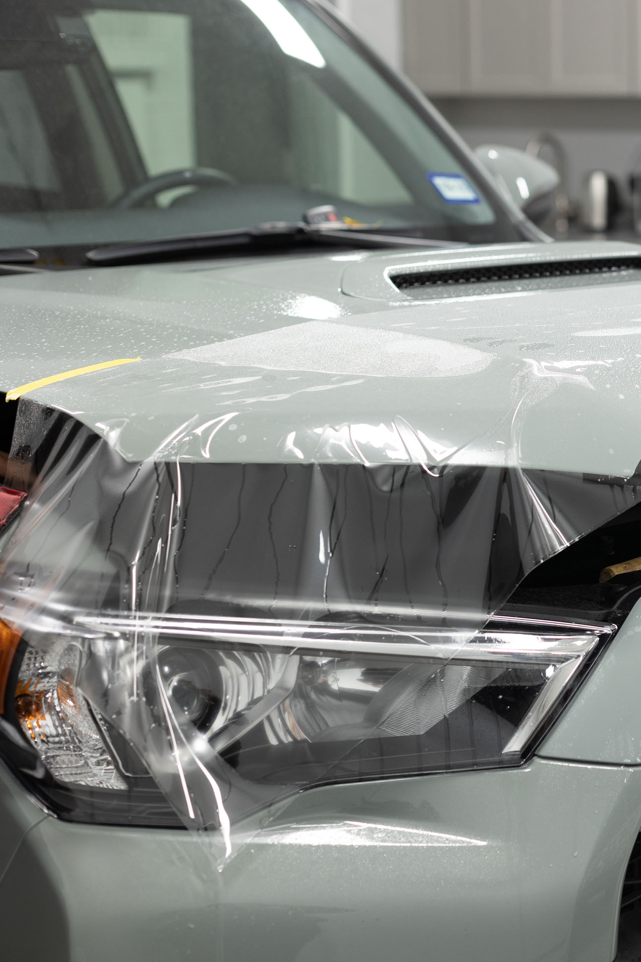 Paint protection film installed on hood of gray car in Dallas Texas at Classic Pinstriping shop
